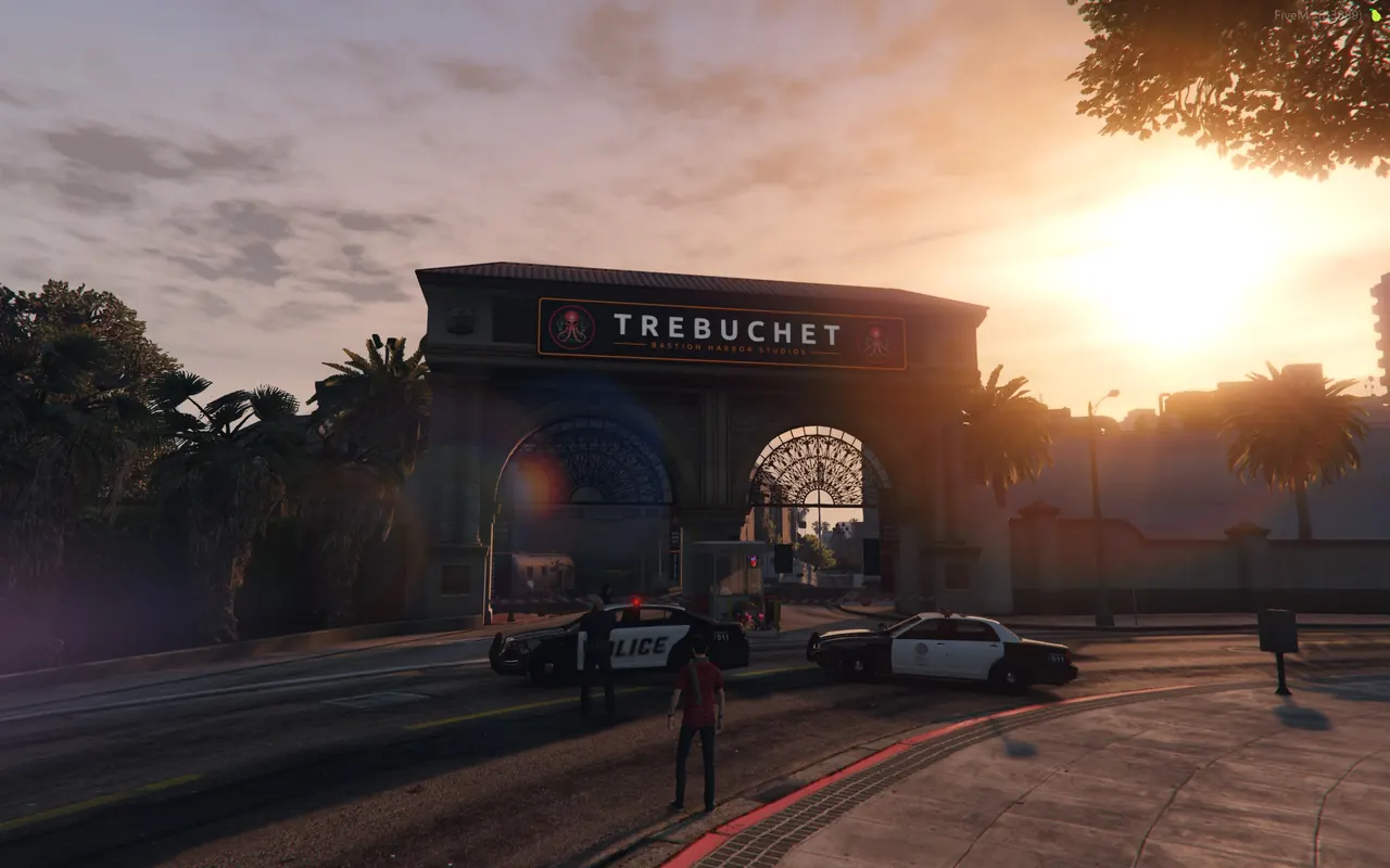 Police cruisers with lights on at the lot gate